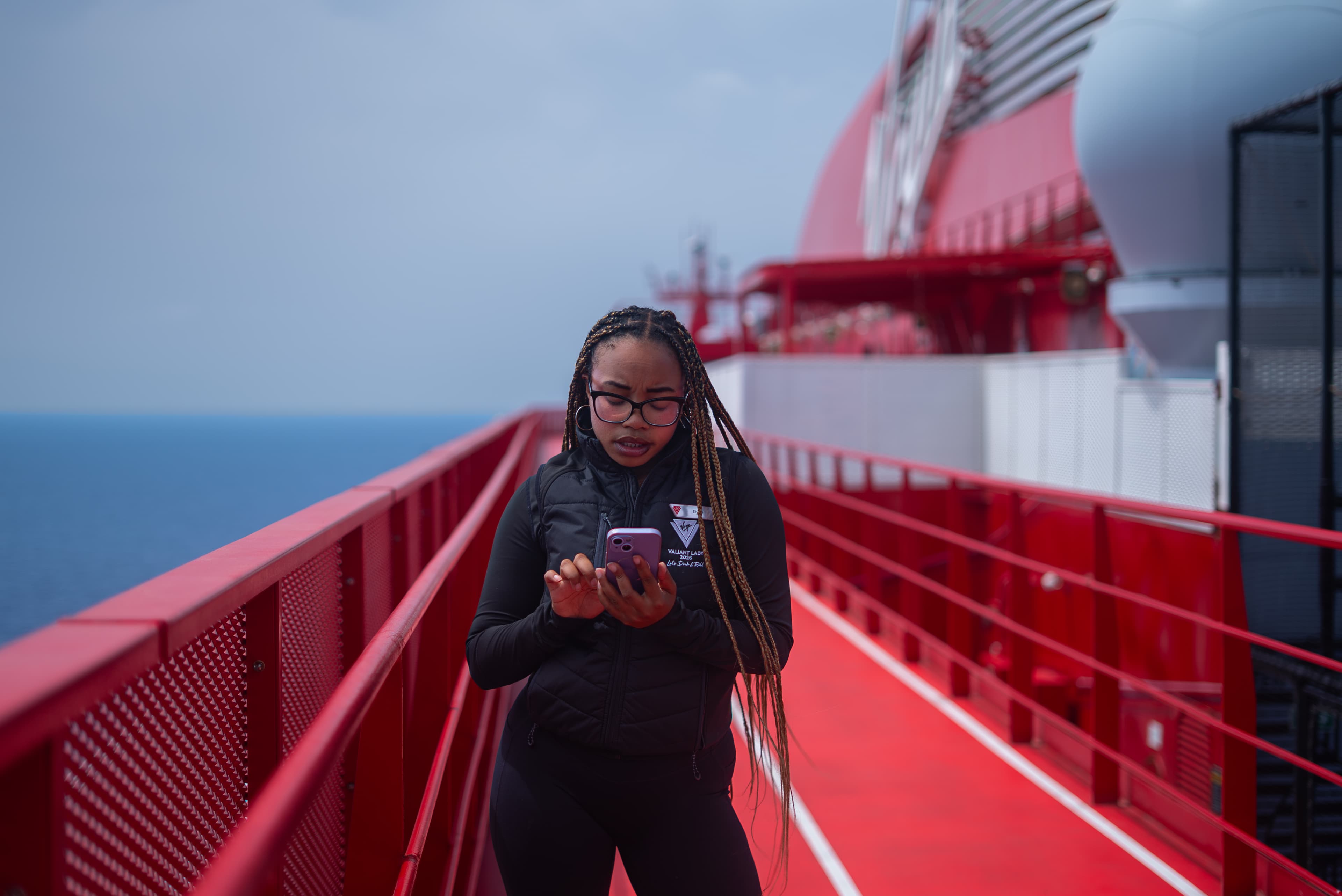 Crew member using the Crew Mingle app onboard a cruise ship to check their itinerary.